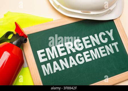 Emergency evacuation plan with fire extinguisher and safety gear on a table Stock Photo