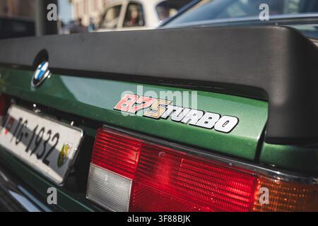 Lindau, Switzerland, August 9, 2026. Close up view of the door panel and iconic gold Alpina side decal graphic on a metallic green classic sports car. Stock Photo