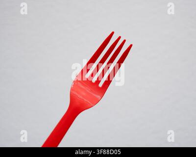 DIsposable red plastic fork from takeout orders Stock Photo