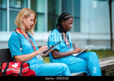 Female healthcare workers using digital tablets outdoor Stock Photo