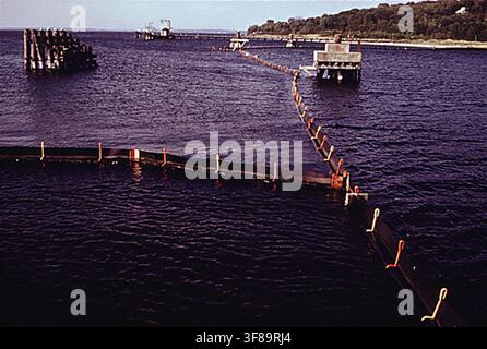 The North East Petroleum Tanker Terminal at Tiverton, the largest such terminal in the Northeast, with a boom system surrounding each ship to contain oil, as part of the Environmental Protection Agency's DOCUMERICA program, May 1, 1973. Stock Photo