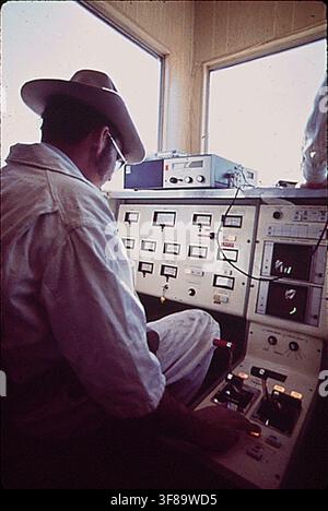 A technician works at the data control center for the Linear Induction Motor Test Vehicle at the Department of Transportation's High Speed Ground Test Center, a site for experimental work on new methods of high-speed ground transportation, on March 1, 1972. Stock Photo