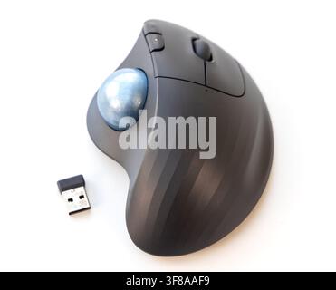 A dark gray ergonomic trackball mouse is on a white background Stock Photo