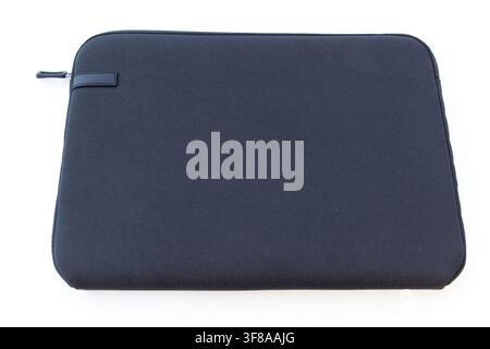 A dark blue laptop sleeve with a zipper lies on a white surface Stock Photo