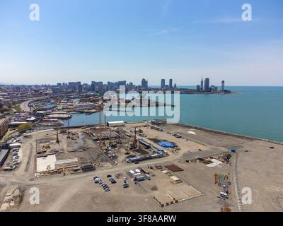 Batumi city on the black sea coast featuring an industrial port, a bustling urban skyline, and active construction work on a new development project a Stock Photo