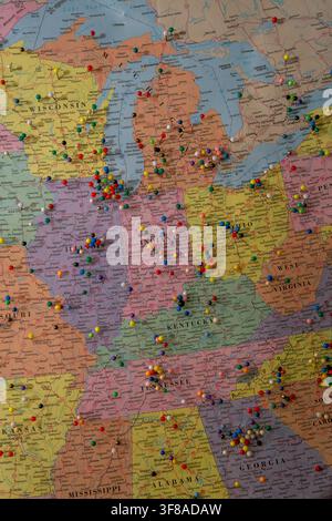 Large wall map of the United States densely covered with hundreds of colorful pushpins marking locations across the country Stock Photo