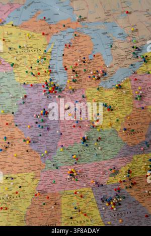 Large wall map of the United States densely covered with hundreds of colorful pushpins marking locations across the country Stock Photo