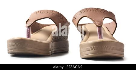 pair of beige wedge sandals isolated white background, women footwear with platform heel and textured straps in close-up side view Stock Photo
