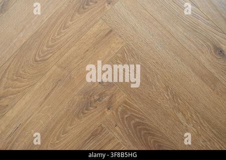 Natural brown wooden laminate texture arranged in herringbone style. Perfect stock photo for home flooring catalogs, timber textures, parquet flooring Stock Photo