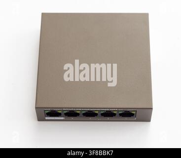 A grey network switch sits on a white background Stock Photo