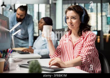 Focus music on headset, woman using AI generative models, chatbot script, advertising agency worker using text to image technology. Editor generating editorial materials for catalog campaigns. Stock Photo