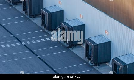 Aerial view of loading docks and empty truck bays at a large logistics warehouse and distribution center in Le Pouzin, Auvergne-Rhone-Alpes, France. Stock Photo