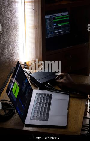 Home Music Studio Setup with Laptop, Audio Interface and Digital Audio Workstation Stock Photo
