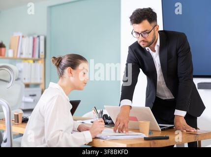 professionals working in a successful company, sit at a table Stock Photo