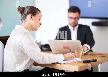 professionals working in a successful company, sit at a table Stock Photo