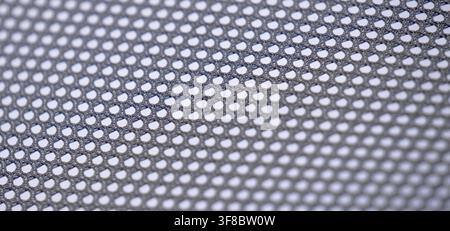 Close-up of gray mesh material with small perforated pattern, suitable for industrial texture, speaker grille, fabric mesh, abstract background Stock Photo
