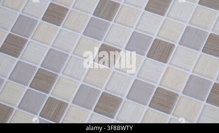 Diagonal view of neutral ceramic mosaic tiles, suitable for bathroom, kitchen, interior design, renovation, architecture, and geometric background Stock Photo