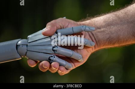 Robot hands with human bioengineering. Human hands in robotic biotech. Robot hands on innovation future. Human hands with robot intelligence Stock Photo