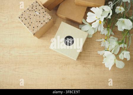 Gift boxes and flowers on a wooden table Stock Photo