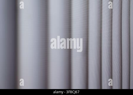 Minimalist gray metallic grid texture with soft bokeh vertical stripes for modern tech or interior backdrops. Stock Photo