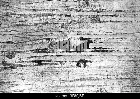 High-contrast black and white photograph showcasing a rough, cracked concrete surface with deep grooves and weathered details, ideal for industrial or Stock Photo