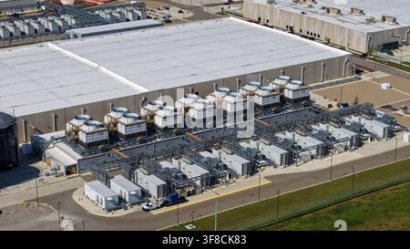 Aerial view of a large data center complex with multiple cooling towers and server units Stock Photo