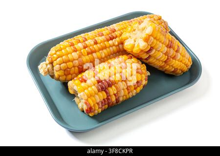 Boiled multicolored waxy corn cobs and cut segments isolated on white background Stock Photo