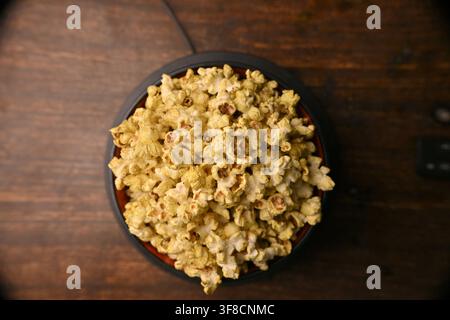 Top View Of Seasoned Popcorn Bowl On Rustic Wooden Table Backgrounds Stock Photo