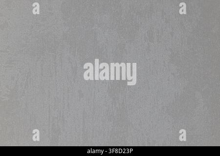 Light grey textured wall surface with a subtle stucco wallpaper pattern. Stock Photo