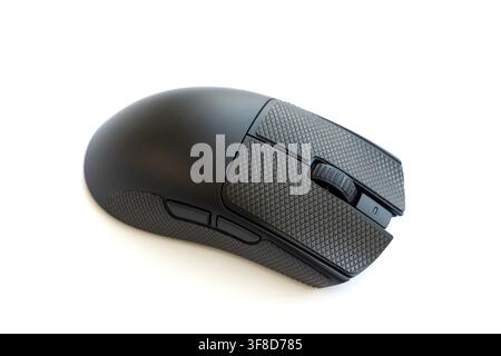 A modern black gaming mouse sits isolated on white background Stock Photo