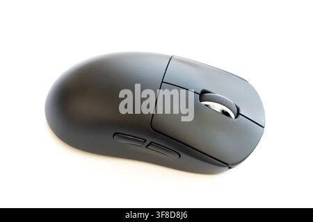 A modern black computer mouse rests on a white background Stock Photo