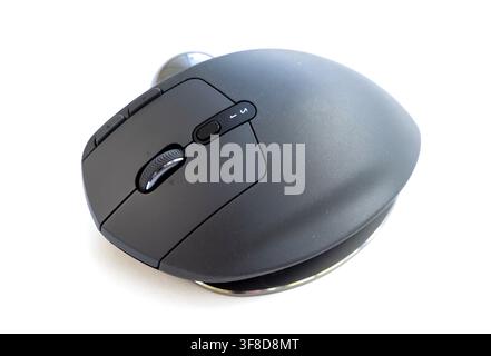 A modern ergonomic computer mouse rests on white background Stock Photo