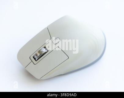 A modern grey computer mouse rests on a white background Stock Photo