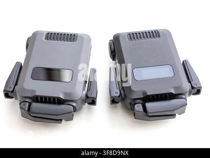 Two folded small drones rest on a white surface Stock Photo