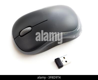 A wireless computer mouse and USB receiver on a white background Stock Photo
