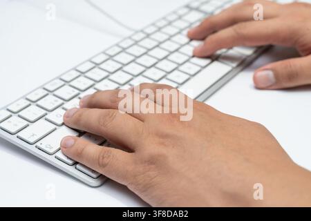 Working at home with laptop men writing a blog. Typing on a keyboard. Programmer or computer hacker Stock Photo