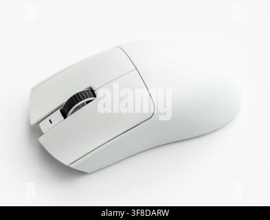 A modern white computer mouse sits on a white background Stock Photo