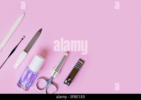Manicure set and nail polish on side of pink background with copy space Stock Photo