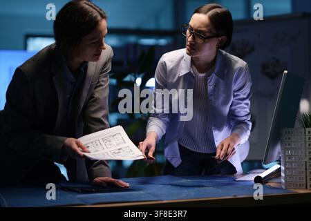 Women architect designers discuss building plans in office Stock Photo