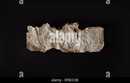 Vintage Burnt Paper Fragment with Wrinkled Texture on Black Background — Historical and Artistic Concept Stock Photo