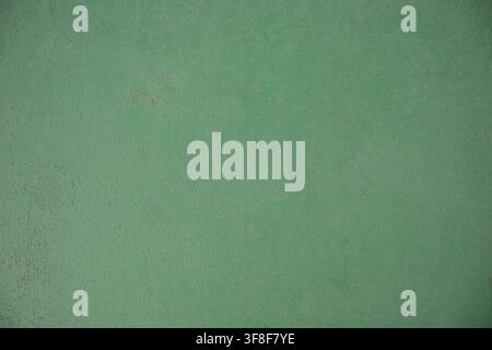 Green painted concrete wall texture with fine cracks and weathered surface Stock Photo