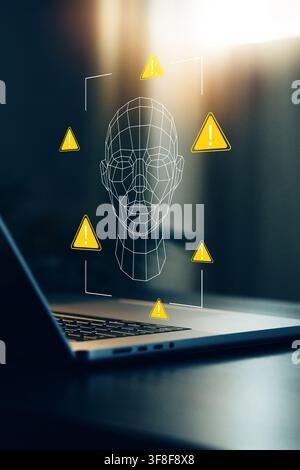 Deep fake technology warning displayed on a laptop screen with a digital face outline Stock Photo