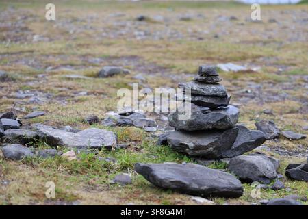 A stacked stone cairn standing on rocky tundra ground at Nordkapp, Norway. Stock Photo