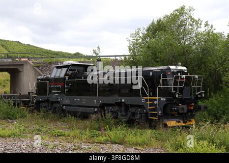 Black Railcare railway maintenance locomotive in Kiruna, Sweden, on a summer day, used for railway infrastructure work. Stock Photo