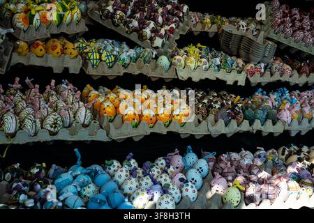 Rows of beautifully hand decorated Easter eggs arranged for sale at a traditional spring market with vibrant seasonal craftsmanship Stock Photo