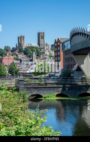View of Lincoln city centre and Cathedral from the river Witham and train station in the city centre. Stock Photo