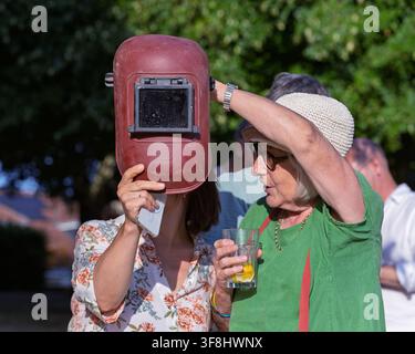 Chippenham,Wiltshire, UK. 12th August 2026. Spectators gather in Monkton Park to watch the partial solar eclipse in Chippenham, Wiltshire. People of all ages enjoyed the celestial event, using specialised eclipse glasses and protective solar filters to safely view the moon passing across the sun. Credit: John Lynch / Ģ����ý Live News Stock Photo
