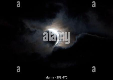 partial solar eclipse as seen through the cloud over belfast lough, 12th august 2026 Stock Photo