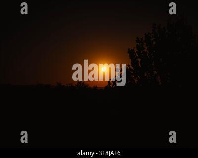 Partial solar eclipse in 2026 at the city of Zagreb, Croatia when moon covered part of the sun at sunset Stock Photo