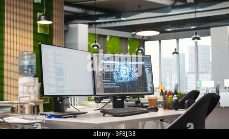 Empty startup office with artificial intelligence program running on PC monitors used by programmers. AI industry startup workspace leveraging machine learning technology Stock Photo